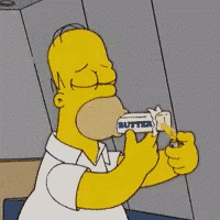 homer simpson is eating a bar of butter with his eyes closed