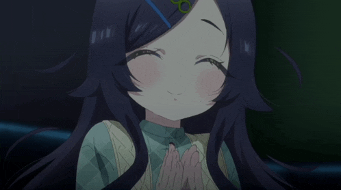a girl with purple hair is smiling with her hands folded in front of her face