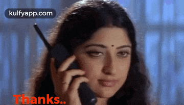 a woman is talking on a cell phone and says thanks ..