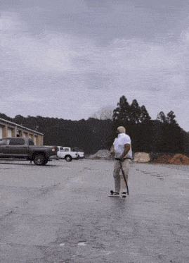 a man is walking down a street with a skateboard