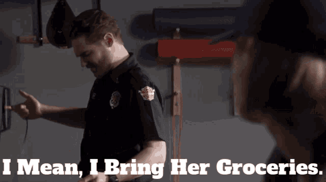 a man in a police uniform says " i mean i bring her groceries " while standing next to another man