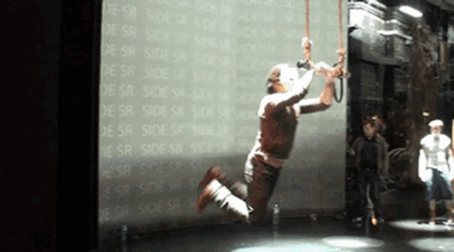 a man is jumping in front of a wall that says side sr on it