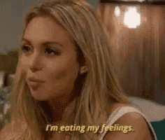 a woman is eating her feelings while sitting down .