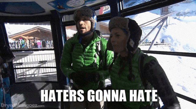 a man and woman in a ski lift with the words haters gonna hate below them