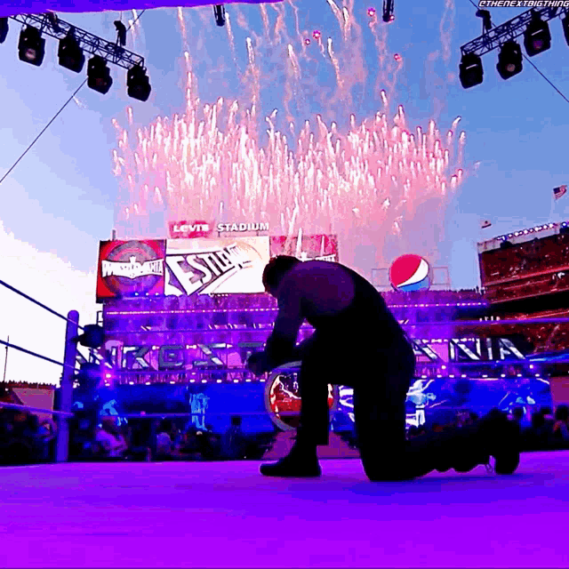 a man is kneeling in front of a levi 's stadium