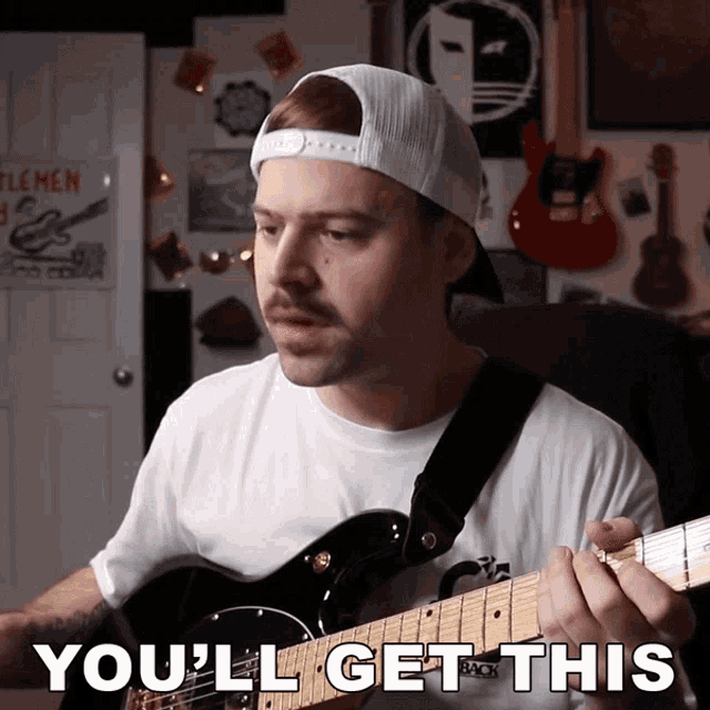 a man playing a guitar with the words you 'll get this above him
