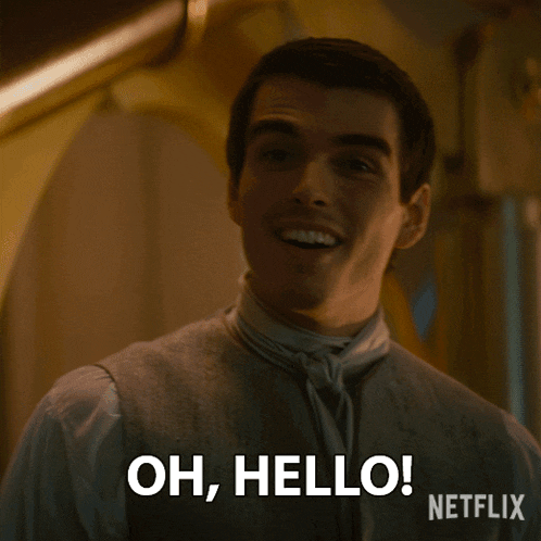 a man is smiling and says " oh hello "
