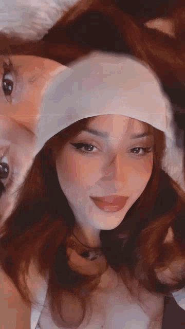 a woman wearing a white headband looks at the camera