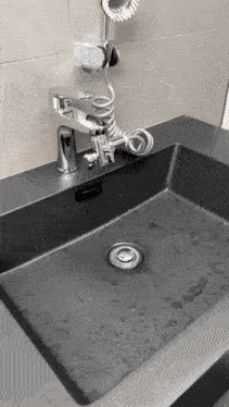 a bathroom sink with a faucet and shower head