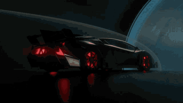 a black car with red lights on the tires