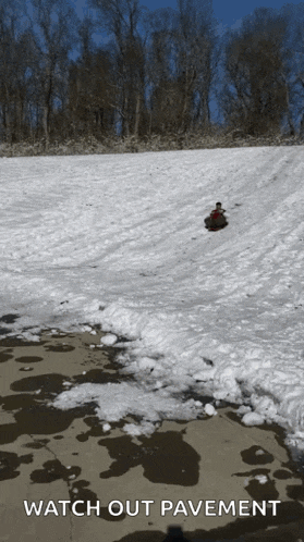 a person sledding down a snow covered hill with the words watch out pavement below
