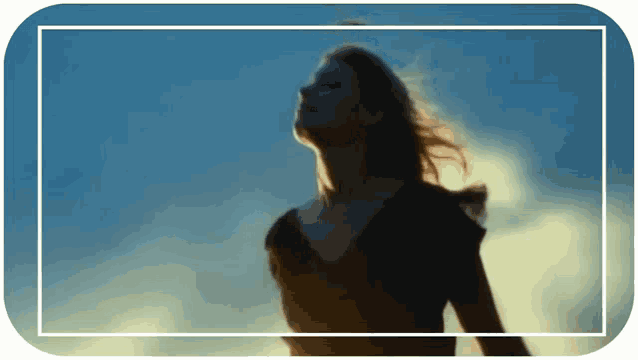 a woman stands in front of a blue sky