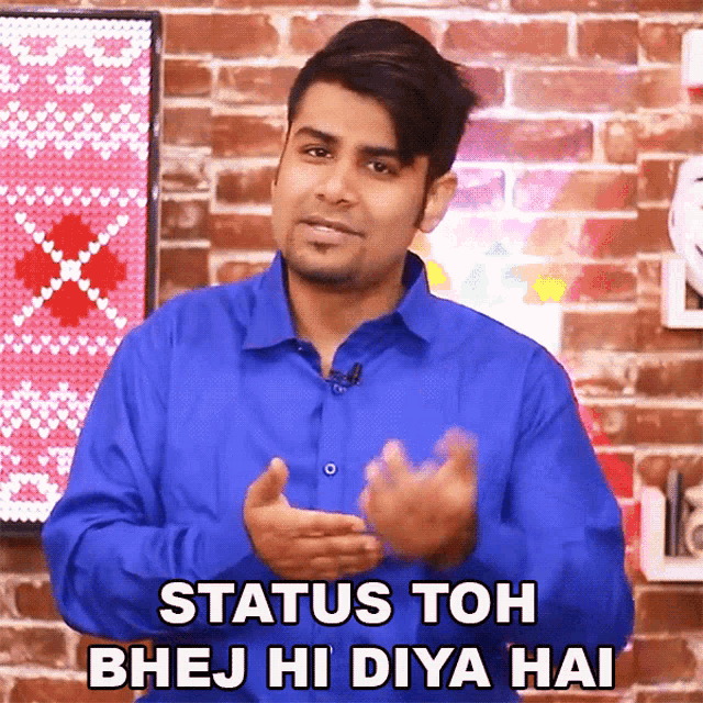 a man in a blue shirt says " status toh bhej hi diya hai " in front of a brick wall