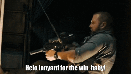 a man holding a gun with the words " helo lanyard for the win baby " below him