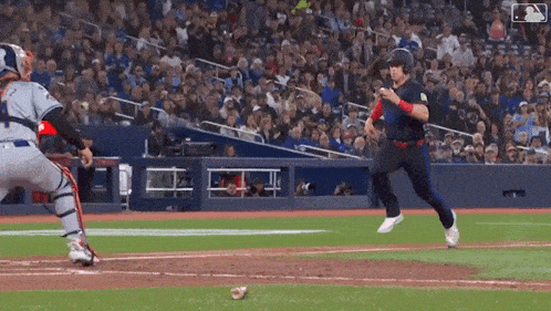 a baseball player is running towards a can on the field during a game