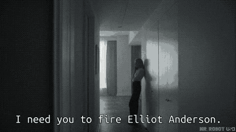 a woman leaning against a wall in a hallway says i need you to fire elliot anderson