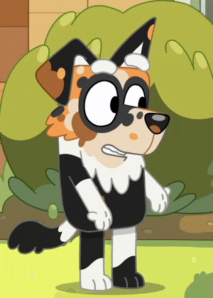 a cartoon dog is standing in the grass and making a face