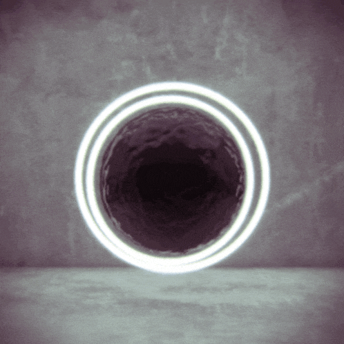 a white circle is surrounding a dark hole