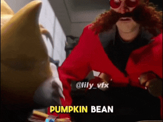 a man in a red jacket with a mustache and glasses is talking to a dog who is wearing a pumpkin bean costume