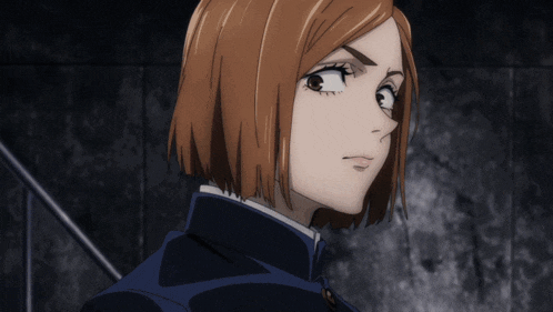 a close up of a woman 's face with a serious look on her face