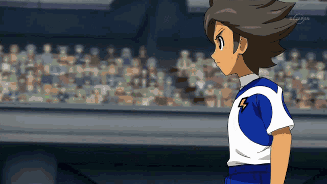 a boy in a blue and white shirt with a lightning bolt on his chest
