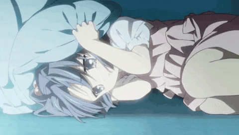 a girl in a pink dress is laying on her stomach on the floor .