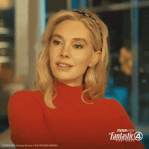 a woman wearing a red sweater with the fantastic 4 first steps logo on the bottom