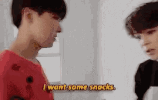 two young men are talking and one of them says i want some snacks .