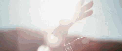 a close up of a person 's hand holding a bottle of water .