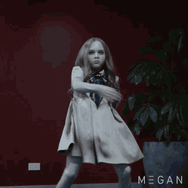 a little girl in a white dress is dancing in front of a potted plant with megan written on it