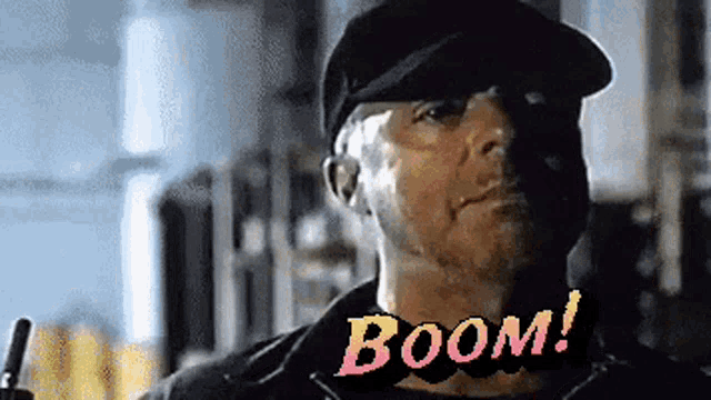 a man wearing a hat with the word boom written on the bottom