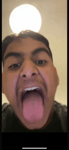 a man is sticking his tongue out and making a face