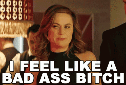 a woman says " i feel like a bad ass bitch " in front of a man in a suit
