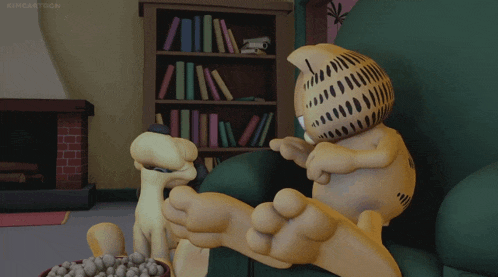 garfield is sitting on a couch with a bowl of peanuts