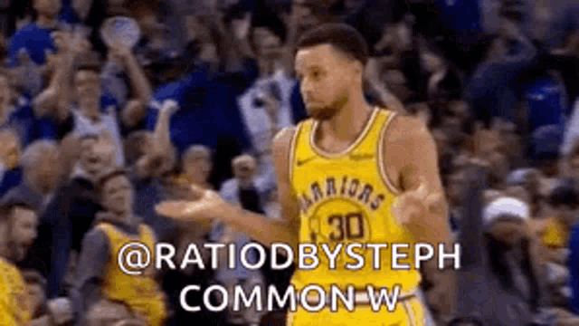 a basketball player is standing in front of a crowd and talking to them .
