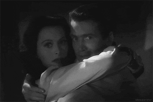 a black and white photo of a man and woman hugging with the caption idlesuperstar