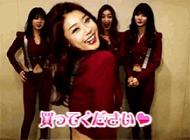 a group of girls are standing next to each other and one of them is smiling .