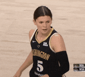 a woman wearing a washington jersey with the number 5