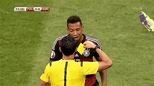 a soccer referee is giving a yellow card to a player .