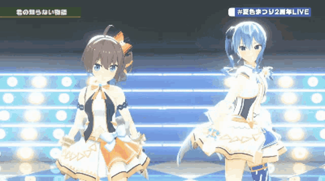 two anime girls are dancing on a stage and the words live are on the bottom right