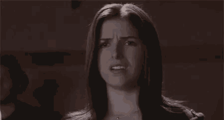 a woman is making a funny face with her mouth open .