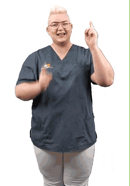 a woman wearing a scrub top with a smiley face on the front