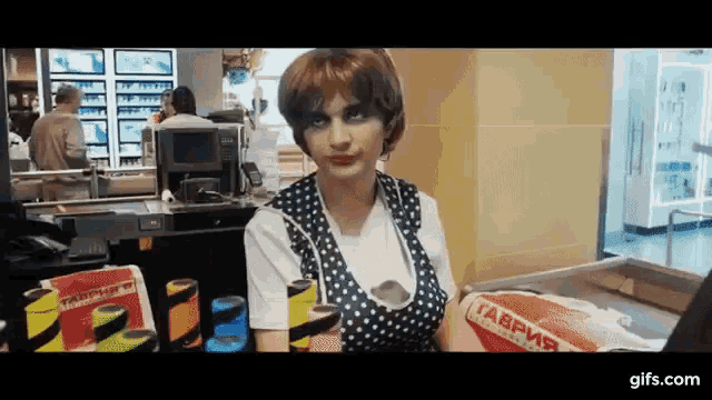 a woman in a polka dot apron is holding a bag that says ' tabpy ' on it
