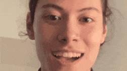 a close up of a person 's face with their mouth open and their tongue sticking out .
