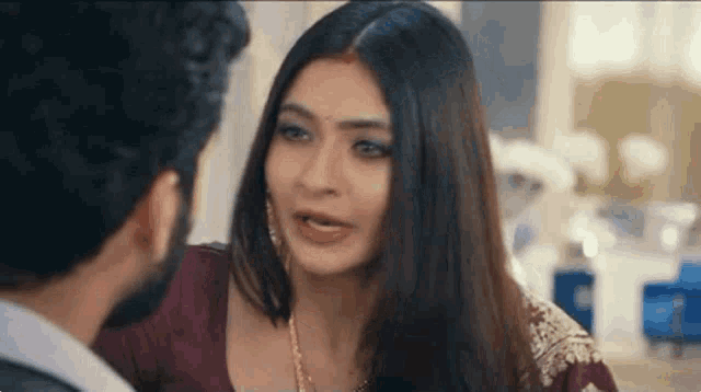 a man and a woman are looking at each other and talking to each other .