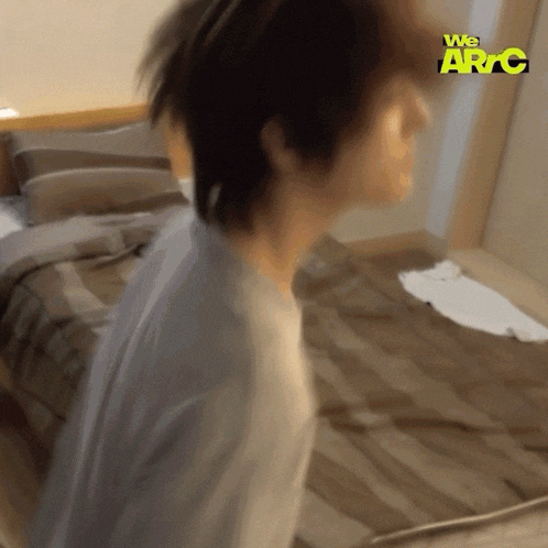 a blurry photo of a person in a bedroom with the words we arc on the bottom