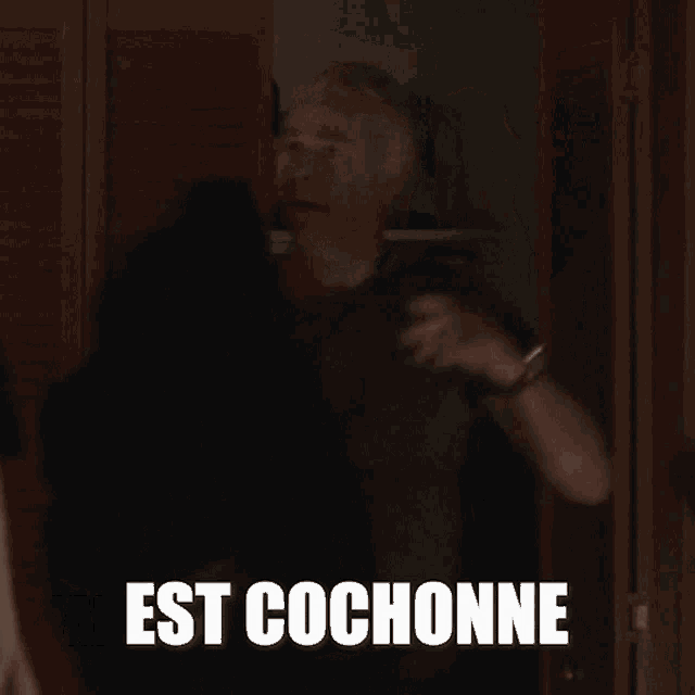 a man is standing in a doorway with the words mais crise qu'est epaisse above him