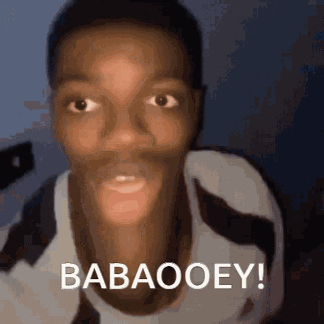 a close up of a man 's face with the words babaooey on the bottom right