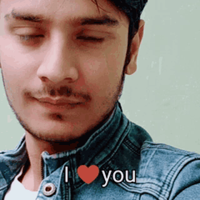 a man in a denim jacket says i love you with a red heart