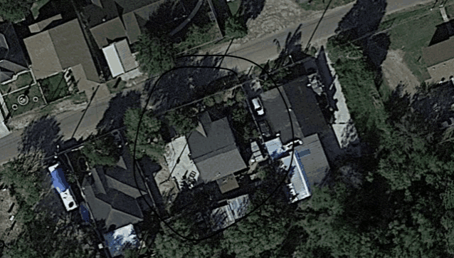 an aerial view of a residential area with a circle around the house
